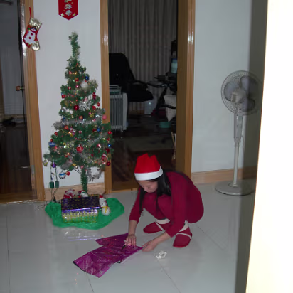 Christmas_2005-002 Christmas elf wrapping gifts. Mine I hope!