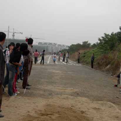 Sports_Day_2005-011 A long jump contestant starts her run.