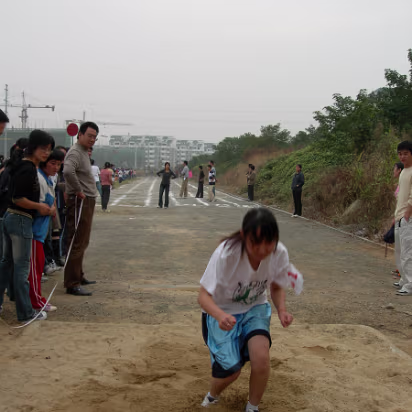 Sports_Day_2005-012 The landing is good and the judges will record her distance.
