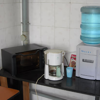 Guanghua-House-06 The necessities of life are here. Bottled water, coffee, oven for pizza!