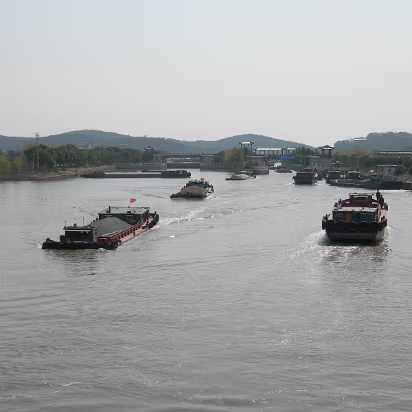 LiHu-02 Barges carrying sand and gravel up a river are a common sight.