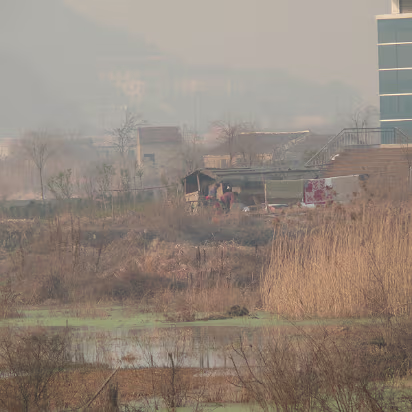 CampusW-14 A villager who would not give up his lifestyle when the university came. If you get the fullsize image, you can see the old couple.