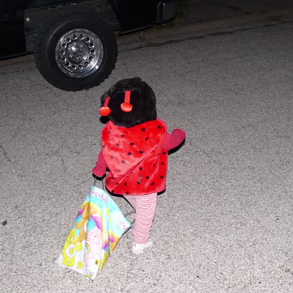 Halloween_2007-020 Ladybug dragging her bag of candy towards another house.