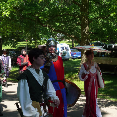 Olde_English_Faire-008 A knight walking with his squire and his lady.
