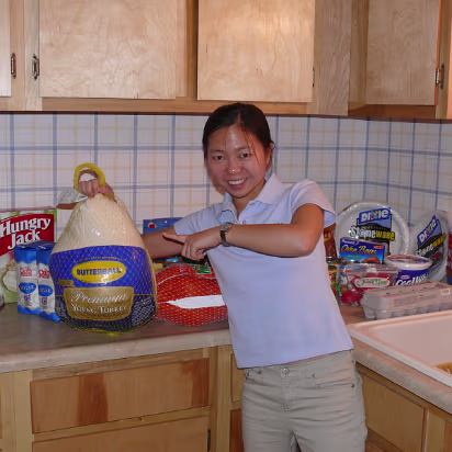 Thanksgiving_2007-001 Hanhan with all the food, including a 11 Kg Butterball turkey.