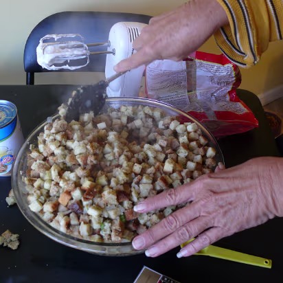 Thanksgiving_2007-014 Mixing the stuffing for the bird.