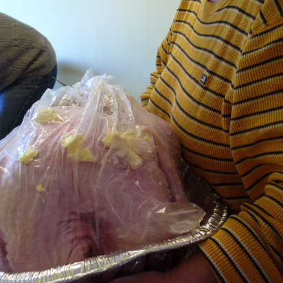 Thanksgiving_2007-019 The turkey is bagged and in the pan on the way to the oven.