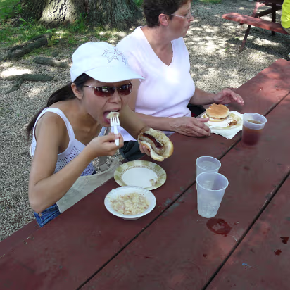VolksFest_2007-001 Hanhan enjoying some German food. Bratwurst with sauerkraut and German potato salad. Yum!