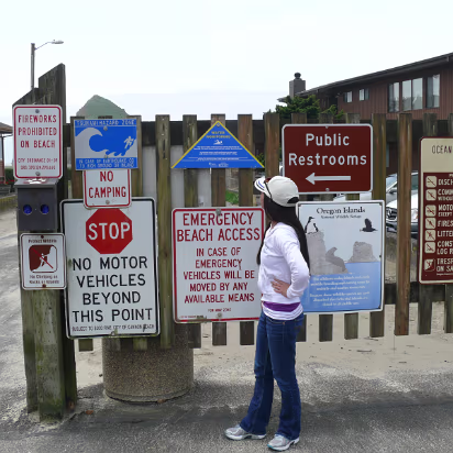 Ocean-003 Examining the many rules at Cannon Beach.